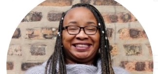 Westinghouse College Prep High School teacher Nina Hike, wearing glasses and smiling in front of a brick wall. Westinghouse College Prep High School teacher Nina Hike, wearing glasses and smiling in front of a brick wall.